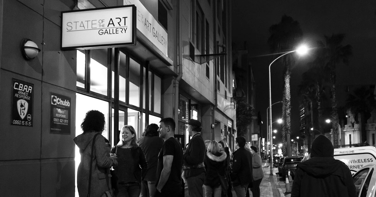 art enthusiasts on the pavement outside StateoftheART Gallery